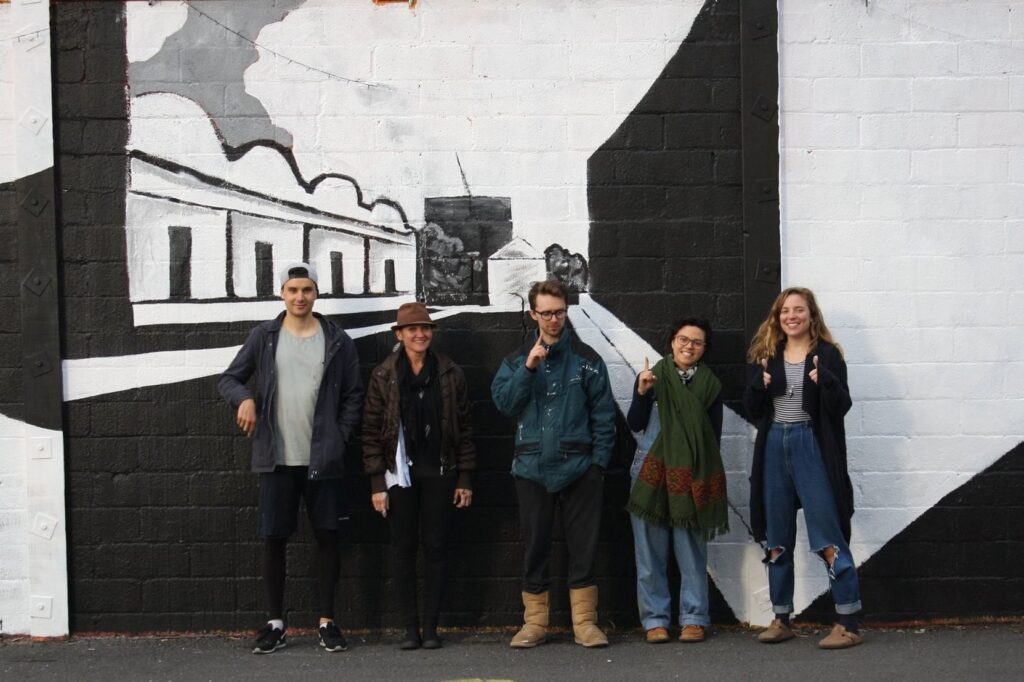 Community volunteers helped paint the mural on-site at Jewell Station in the "Art of recovery - one day at a time" street art project with residents from VincentCare's Quin House